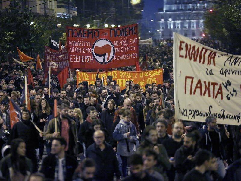 Protesters march in Athens in homage to the victims of a 1973 uprising against the military junta.
