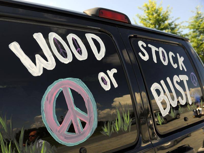Woodstock 50 promoters are fighting former investor Dentsu Aegis, who tried to cancel the concert.