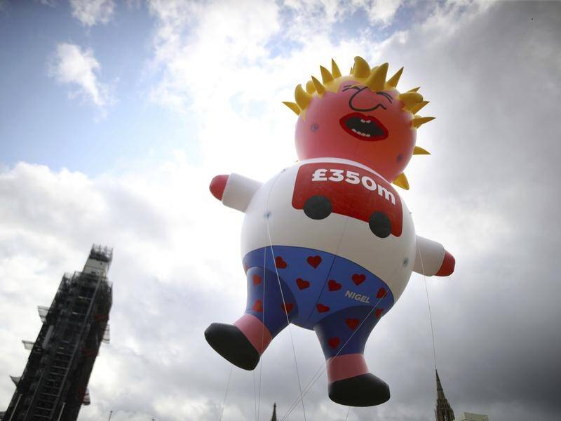 Pro-EU protesters in London have flown a blimp depicting Brexiteer and likely PM Boris Johnson.