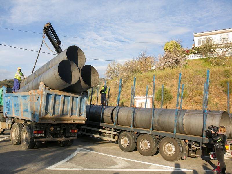 A truck carries pipes for an operation in Spain to rescue a two-year-old boy trapped in a well.