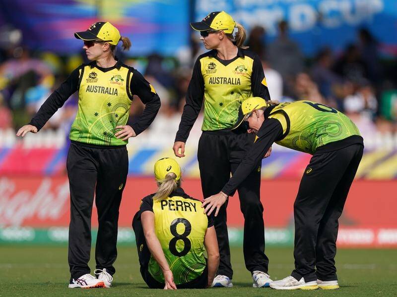 Teammates come to the aid of Ellyse Perry, who was injured during the T20 clash with New Zealand.