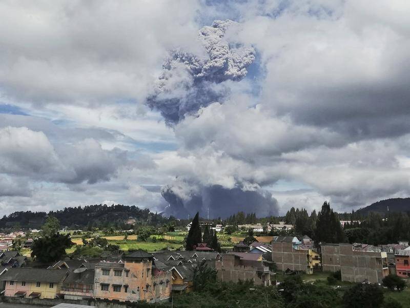 Mount Sinabung spews volcanic materials into the air as it erupts in North Sumatra, Indonesia.
