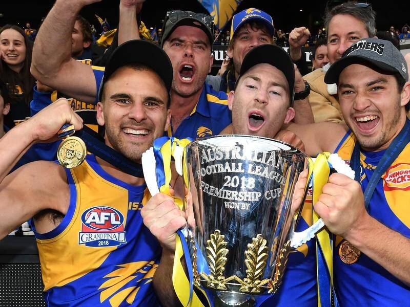 Dom Sheed, Jeremy McGovern and Liam Duggan with the AFL trophy after beating Collingwood.