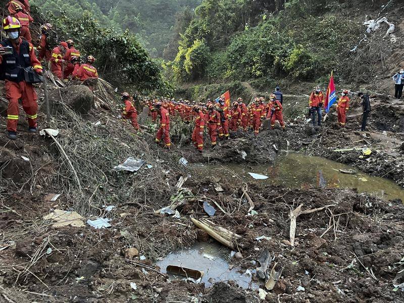 Rescuers have combed mountainous terrain in the search for wreckage from the downed Chinese jet.