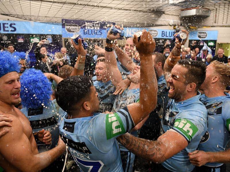 Blues players celebrate their State of Origin series win over Queensland.