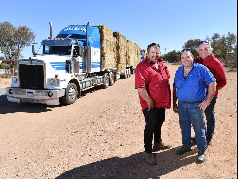 Transport owner Scott Wilson (left) is carting hay to drought-stricken farmers in NSW.