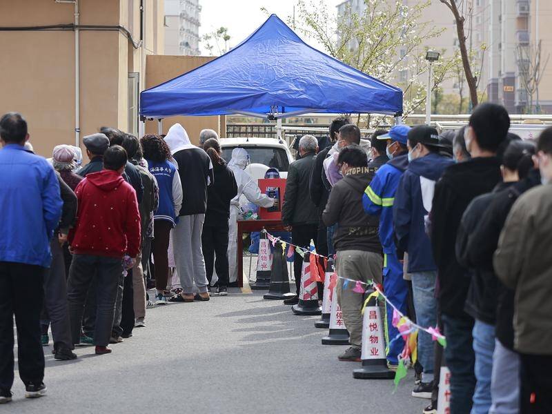 Shanghai residents line up for COVID-19 tests at a residential community under lockdown.