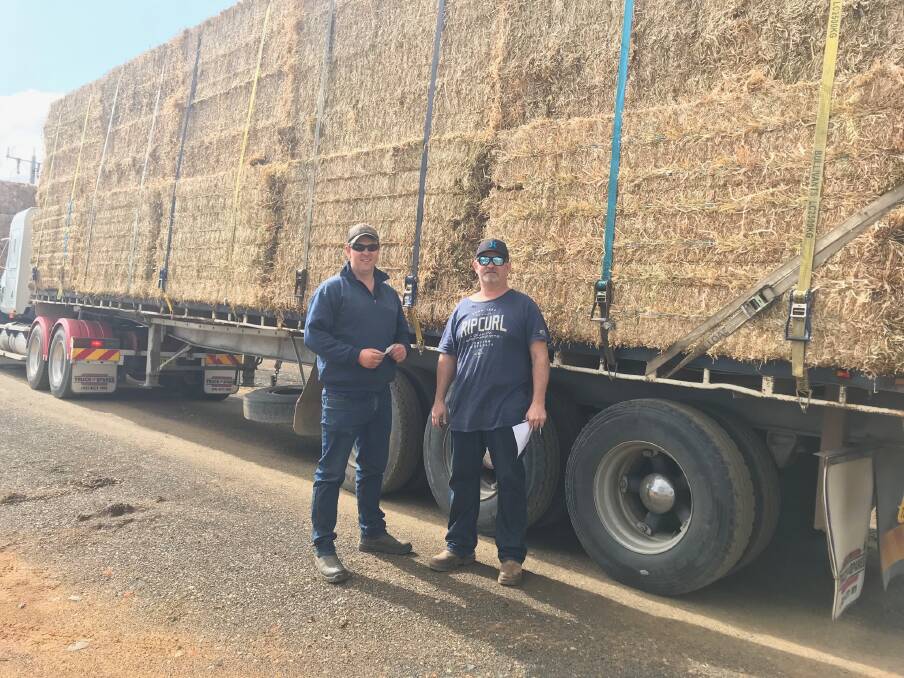 FEED: Local CFMEU Lodge president Curtis Jones (right) with farmer Brad Ellis, from Goroke Victoria, purchasing the hay last week. Picture: SUPPLIED. 