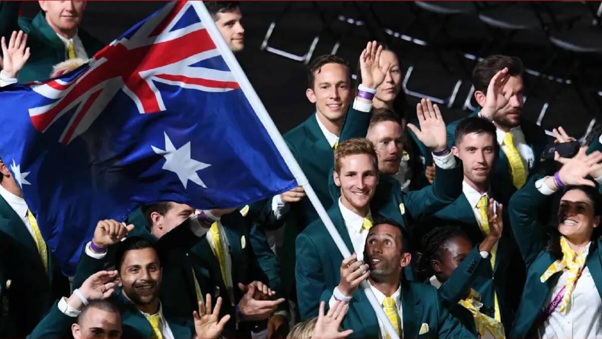 Flag bearer Mark Knowles leads the Australian team. Photo: AAP
