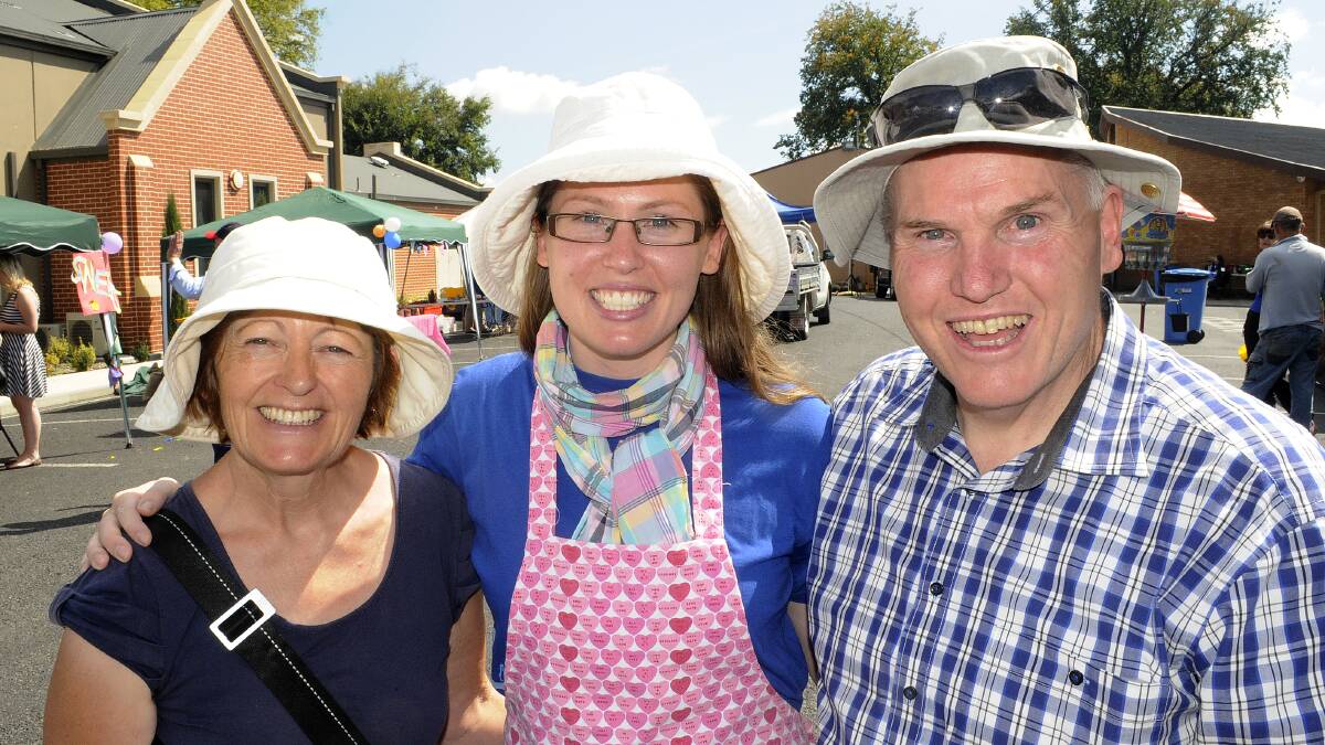SNAPPED: St Michael and St John’s Cathedral community fete. Chris, Rachel and Tony Lonard.