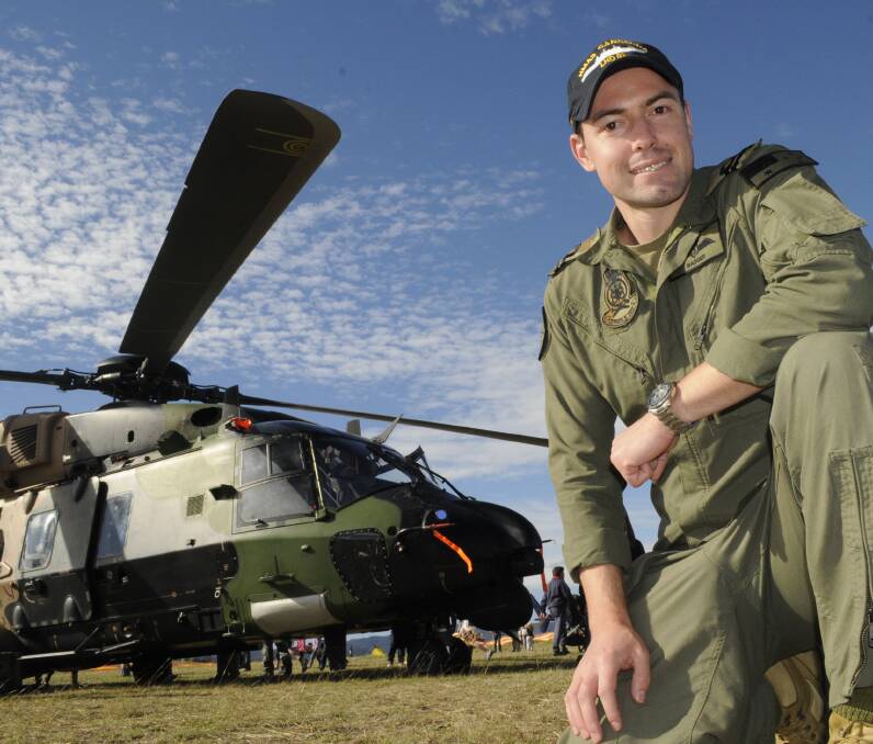 DEFENCE SUPPORT: Royal Australian Navy pilot Lieutenant Lachlan Badger, said the Royal Australian Navy’s MRH-90 Taipan was a hit with the crowd at the Soar Ride and Shine event held at Bathurst Airport. Photo by: Chris Seabrook. 