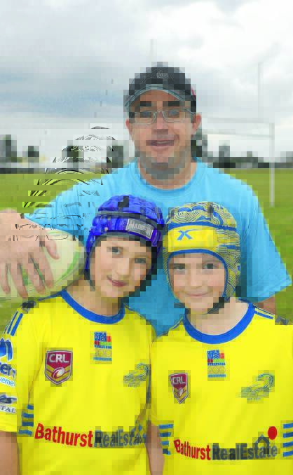 NEW GUIDELINES: Eglinton Eels players Dominic Polsen, 10, and Luke Martinez, 9, with the club’s sports trainer Rod Masman, who welcomes new guidelines for suspected concussion in young contact sport players. Photo: PHILL MURRAY	 060216pfooty