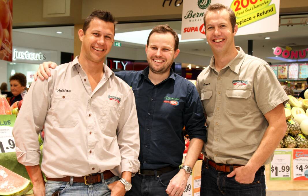 WORKING TOGETHER: Bernardi Group buying and marketing director Joe Bernardi (centre) and Harris Farm Markets co-CEOs Tristan and Angus Harris celebrate the announcement of a new partnership between the family-run businesses. 	051014farm