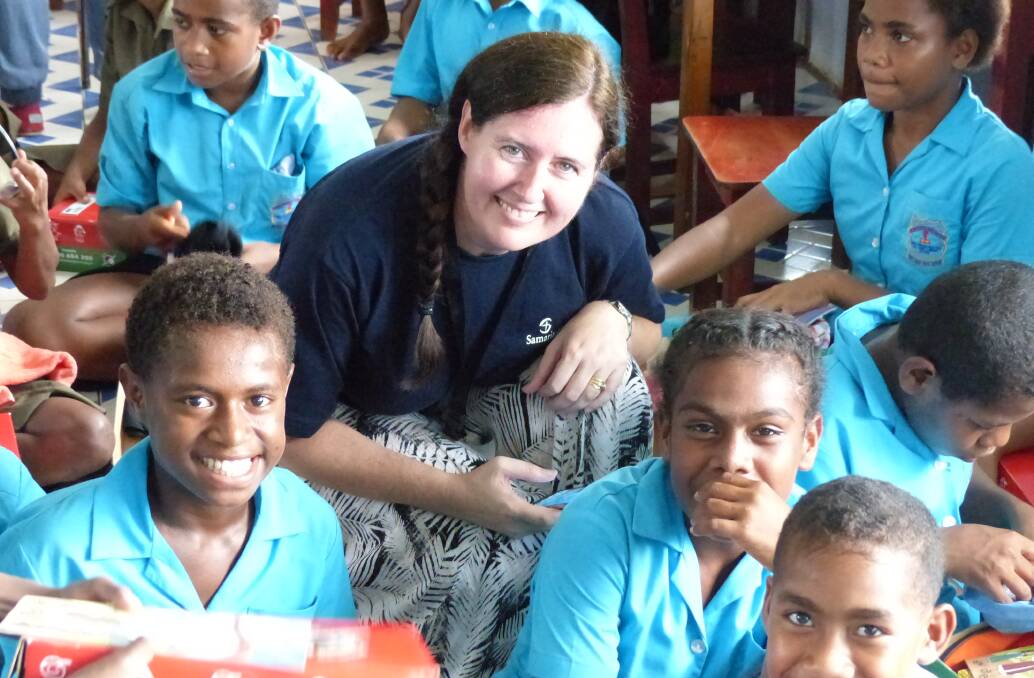 WHAT A PRESENT: Bathurst woman Lisa Limbrick was in Fiji earlier this year to delivers presents from Operation Christmas Child. She has encouraged Bathurstians to get behind the project again this year. Photo: SUPPLIED 	061716fiji9
