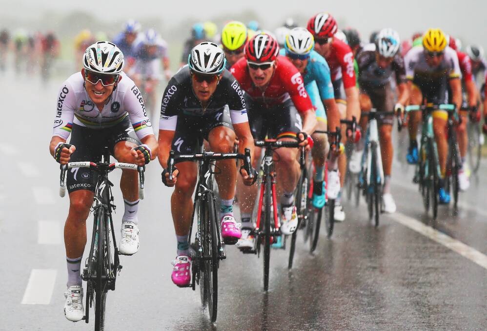 TOUGH DAY: Mark Renshaw’s QuickStep team-mate Michal Kwiatkowski works on the front during stage two of the 2015 Tour de France. While Kwiatkowski was named the most aggressive rider for the stage, QuickStep missed out on the green jersey-yellow jersey double. Photo: GETTY IMAGES 	070615kwiat