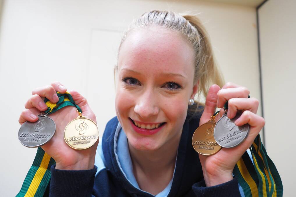 GOLDEN RESULT: Jodie Simson displays her two gold and two silver medals from last week’s School Sport Australia Championships. Photo: ZENIO LAPKA 	072714zsimson1