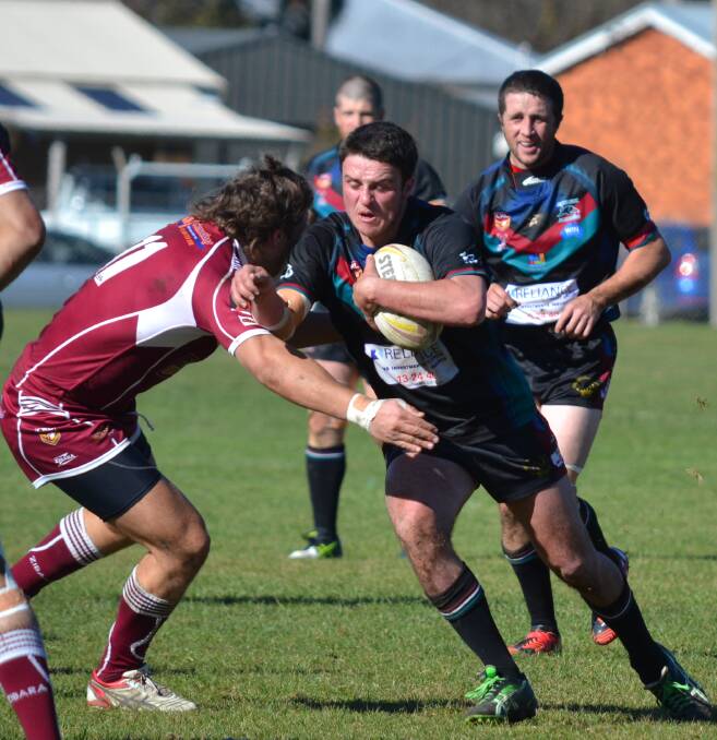 OUT OF TROUBLE: Panthers lock Jake Betts carts the ball up against Blayney – a match in which the Bathurst side started well but then faded. However, on Sunday against Cowra the Panthers were able to get the job done as they won 30-16. Photo: SAM DEBENHAM 	062115sdpanthers13