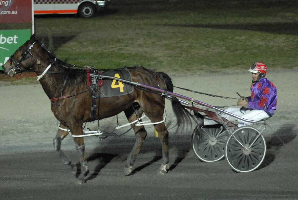 CHERRY ON TOP: Georges Plains trainer-driver Bernie Hewitt took out the 2014 Young Cherry Festival Cup with A Passion For Aces. Photo: CHRIS SEABROOK 	090512ctrots1