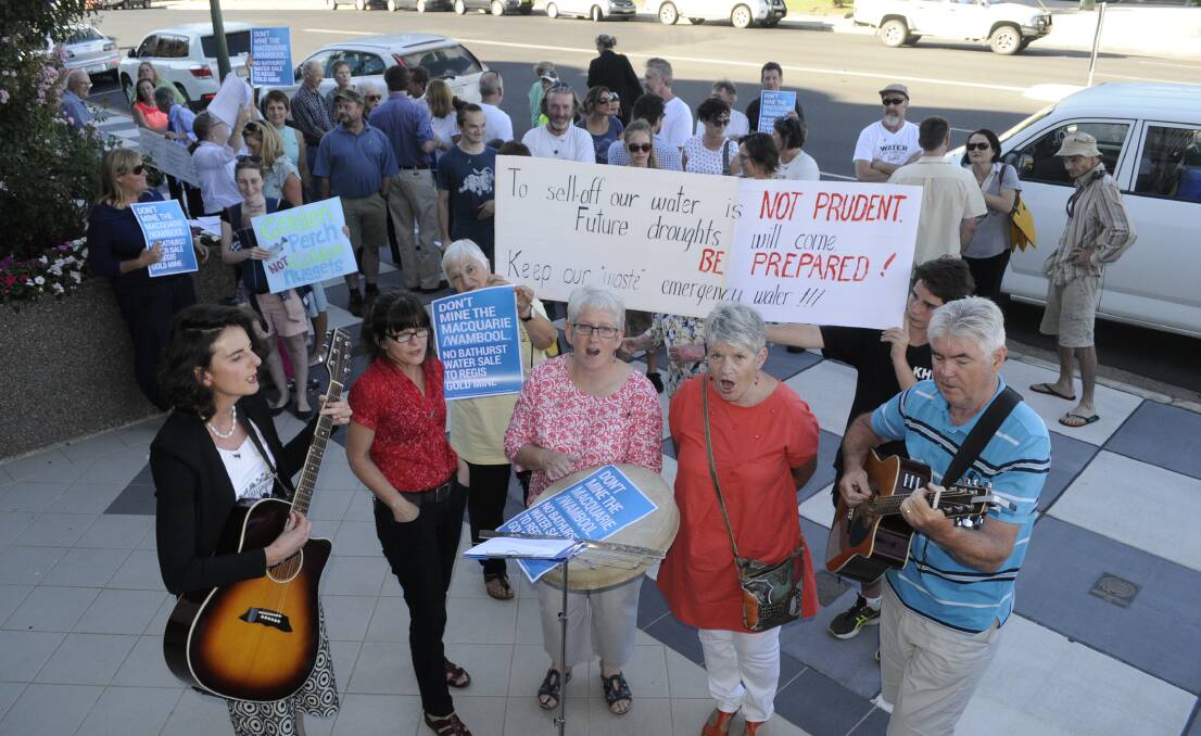 WATER MUSIC: Opponents of the proposed water sale to Regis Resources gathered outside the Bathurst Regional Council chambers before Wednesday night's meeting, holding protest banners and singing their new song, Spirit of the River. Photo: CHRIS SEABROOK	 021716criver1