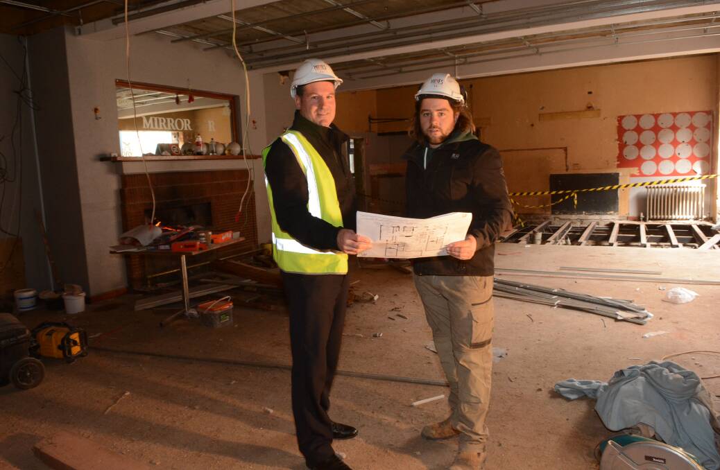 MAKEOVER: David Hines and Mark Donnelly, Hines Constructions’ site foreman for the Park Hotel makeover, check plans for the million-dollar transformation of the CBD pub. Photo: PHILL MURRAY	 081415ppark