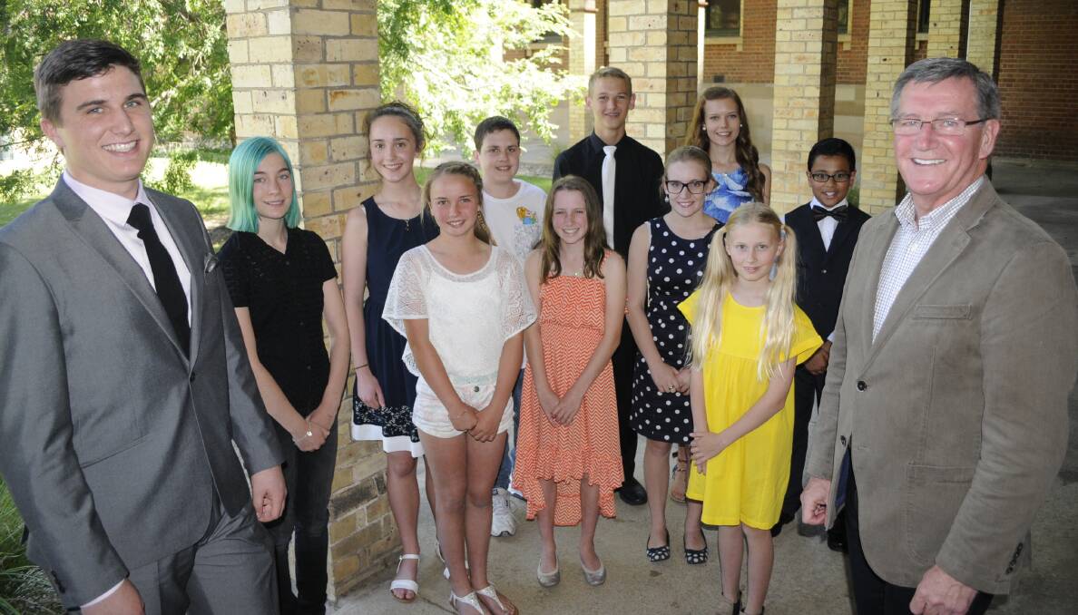 YOUNG TALENTS: Youth Arts Awards winners (middle) Prue Inwood, Rosie Forsyth, Niamh McLean and Ava Pickup and (back) Jade Newham, Emma Russell, Will Hazzard, Hamish McIntyre, Antonia Fish and Jacob George with (front) MC Keegan Bringolf and Bathurst mayor Gary Rush at Saturday’s Showcase Concert. Photo: CHRIS SEABROOK	 121215cmitcon
