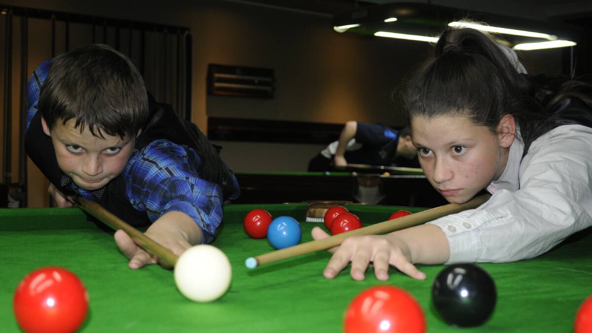 FOCUSED: Denzel, 11, and Jadzia Nicholson, 12, earned high finishes at the recent Australian Snooker Championships at Albury. Photo: CHRIS SEABROOK 	072115csnooker