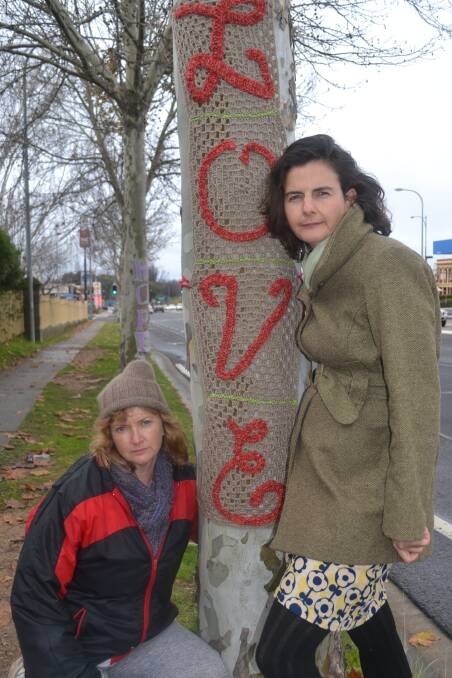 SAVE OUR TREES: River Yarners members Judy Meadley and Sally Neaves helped to wrap crocheted signs around London plane trees on Durham Street. Photo: RACHEL FERRETT 