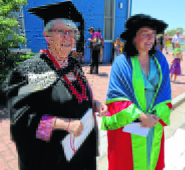 HONOURED: Kathryn Pitkin congratulates Emma Leslie (right) on being awarded an Honorary Doctorate at Charles Sturt University in Bathurst this week. 121814EmmaLeslie