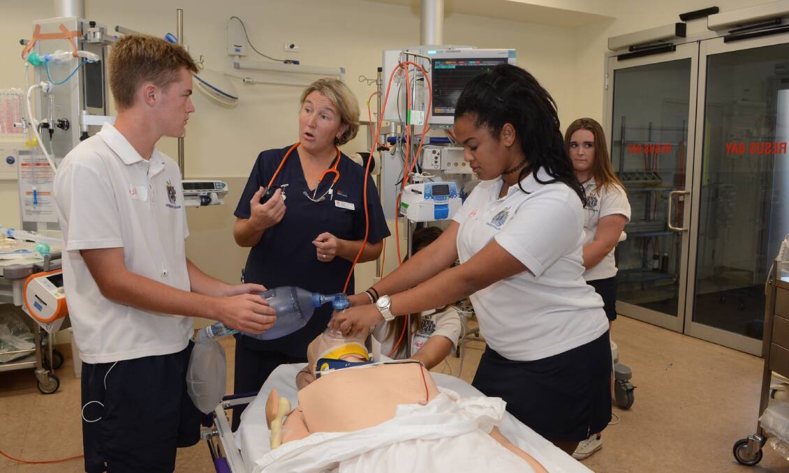 HANDS ON: Bathurst High Year 10 students Josh Broes and Emily Kavwenje received guidance from nurse Alison Parker during a hands-on program held at the hospital to show the teens the graphic effects of risk-related behaviour. Photo: PHILL MURRAY 031115pparty