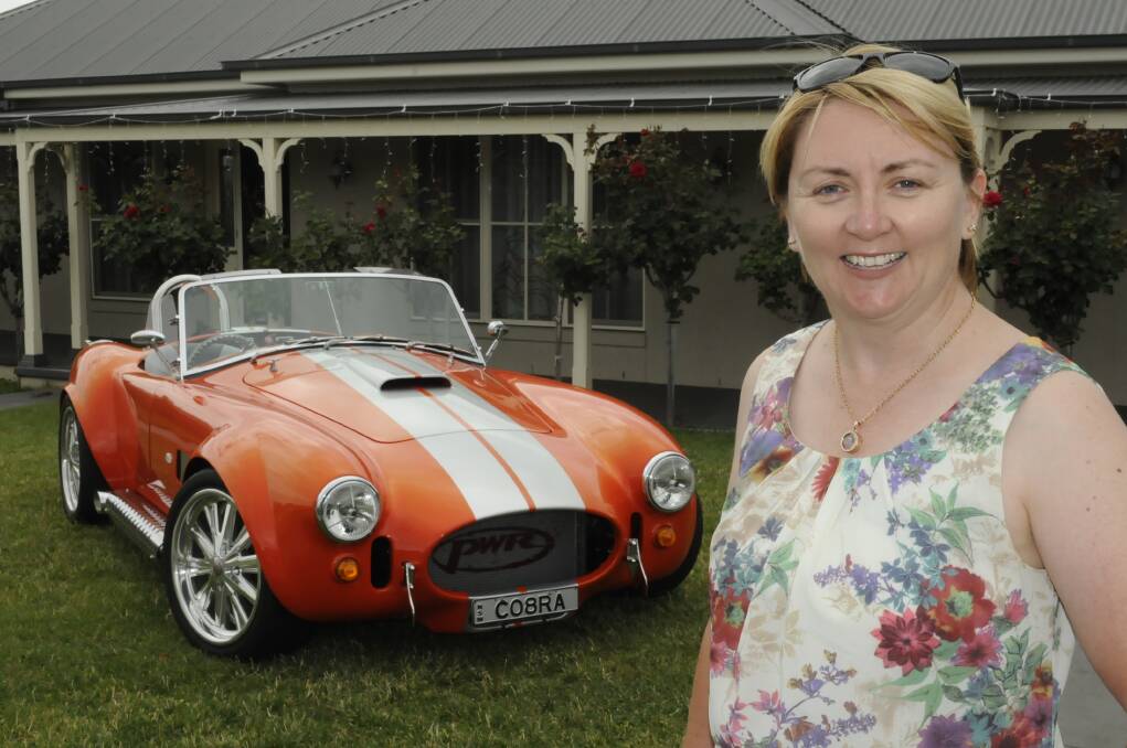 PRIDE AND JOY: New chair of the Bathurst Business Chamber Stacey Whittaker with her fabulous Cobra replica. Photo: CHRIS SEABROOK 122314cobra