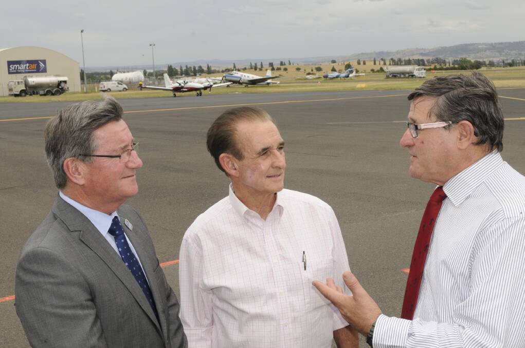 SKY’S THE LIMIT: Bathurst mayor Gary Rush and Calare MP John Cobb, pictured with Bathurst Aero Club president John Nicoll (centre), yesterday announced $5 million in funding for upgrades to Bathurst Regional Airport. Photo: CHRIS SEABROOK	 120815cairprt1