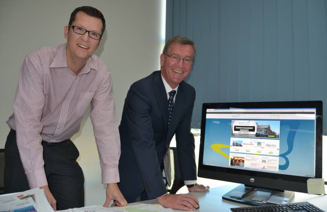 BUSINESS TOOL: Bathurst Regional Council manager economic development Steve Bowman and mayor Gary Rush take a look at the Bathurst Business Hub website which has been up and running for the past couple of weeks. Photo: LOUISE EDDY 051316lehub