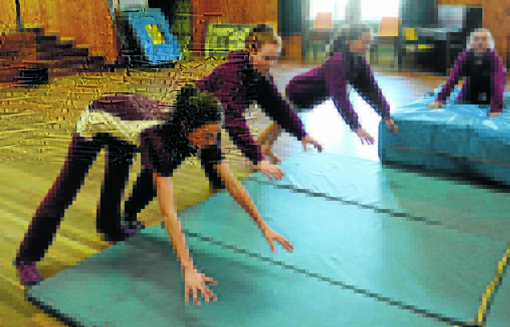NEW PROGRAM: Learning to fall at West Bathurst Public School’s circus class were Sarah Lane, Bobbie-Lee Tobitt and Sophie Thomas. Photo: PHILL MURRAY 081815pwest