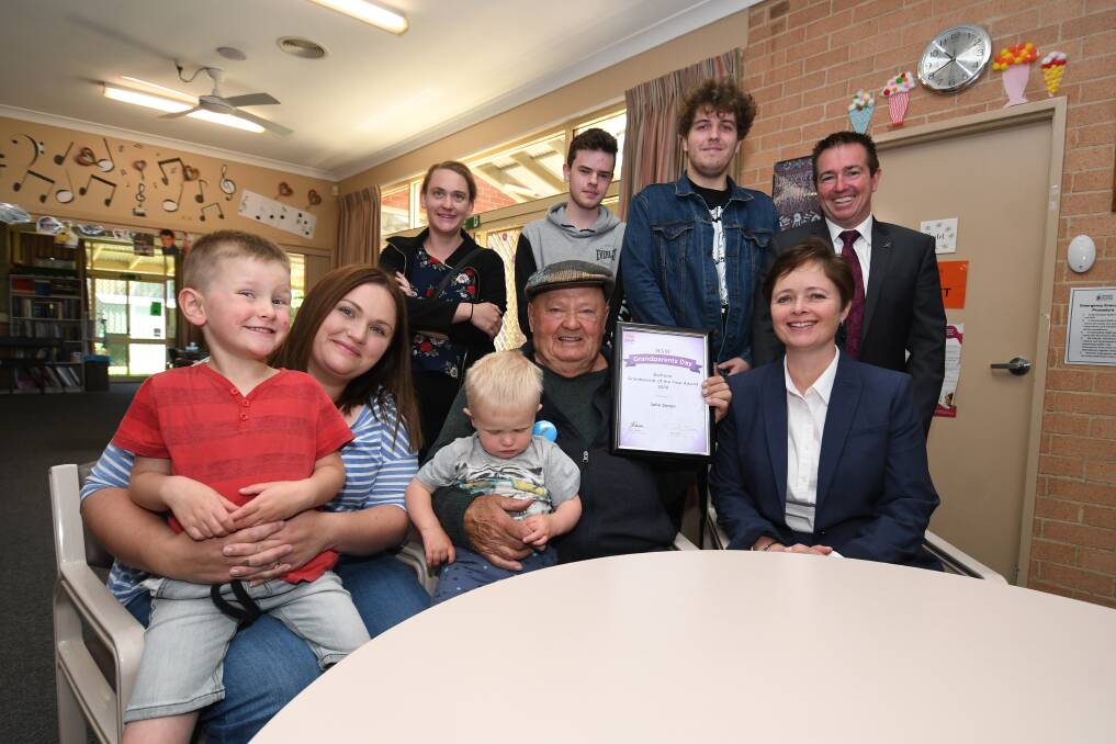 BATHURST GRANDPARENT OF THE YEAR AWARD 2018 : Family members gather round John Simon (centre) along with NSW Ministers Tanya Davies and Paul Toole for a photo. Photo:CHRIS SEABROOK 103018cgdad1