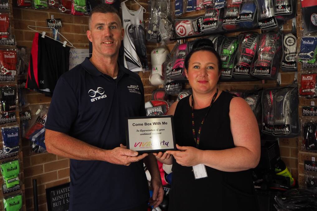 SUPPORTERS OF INCLUSION: Vivability community access manager Ruth Thurtell presenting a plaque of appreciation to Come Box With Me Fitness Hub owner Steve Browne. Photo: SAM BOLT 122118sbviva1