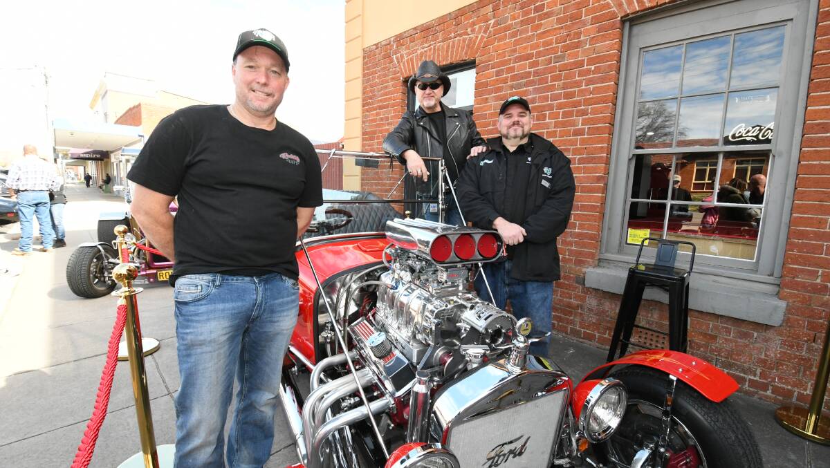 FORD T-BUCKET: Rockabilly Cafe co-owner Steve Ingwersen with Tony Spina and Shannons regional development officer Stuart Jamieson Photo:CHRIS SEABROOK