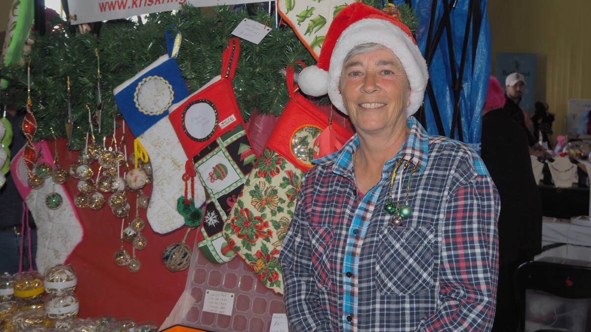 DECORATIVE CLIPS: The Kris Kringle Klip's Aline Bedard with her festive Christmas display at the Bathurst Outdoor Expo and Christmas Markets. Photo: SAM BOLT