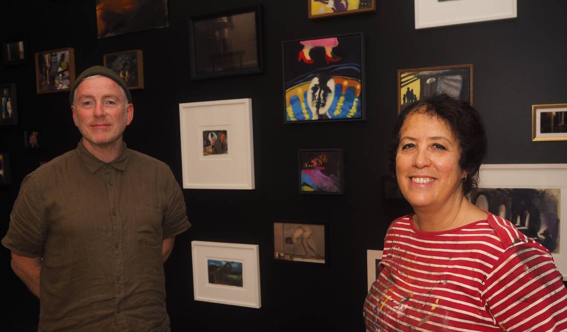 LIGHT IN THE DARK: Artists Steven Cavanagh and Wendy Sharpe with a selection of works from their exhibition, DARK, on display at Bathurst Regional Art Gallery. Photo: SAM BOLT