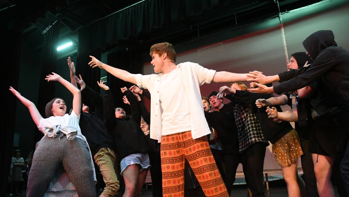 HEAL YOUSELVES: George Sargent's Jesus rehearses 'The Temple' with the chorus for the combined St Stanislaus' College/MacKillop College production of Jesus Christ Superstar. Photo:CHRIS SEABROOK 030919cjcssc1