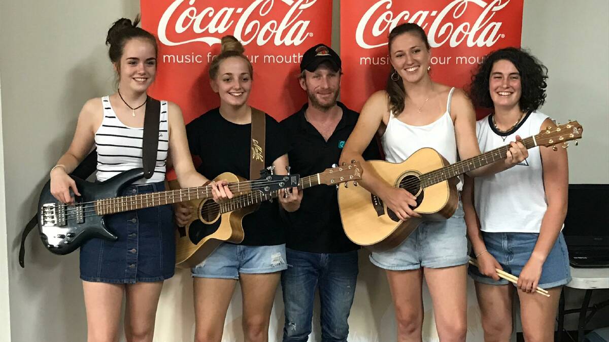 THE BIG STAGE: Bathurst Academy of Music manager Mickey Pye [centre] with Belle Whitwell, Tameka Kennedy, Ash Sproule and Jenna Orpwood. The four musicians entered the Coca-Cola Battle of the Bands competition as Cheviot Drive. Photo: SUPPLIED