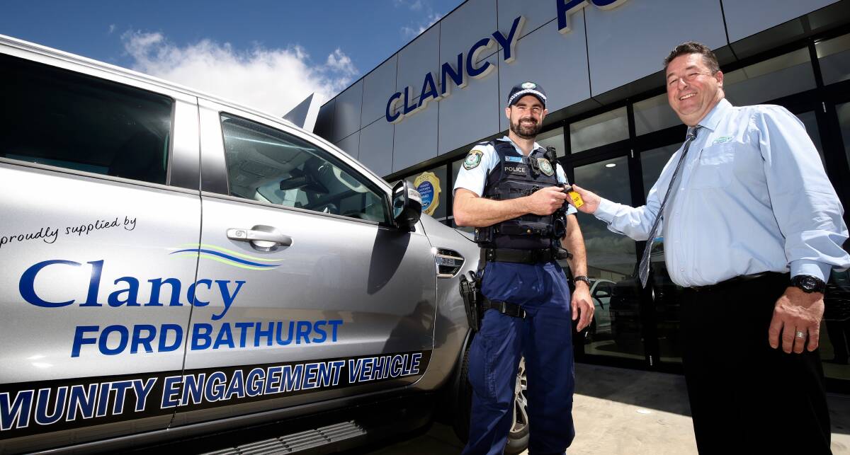 HERE'S THE KEYS: Chifley LAC Senior Constable Darren Carter with Clancy Motors dealer principal Michael Pentecost. Photo: PHIL BLATCH