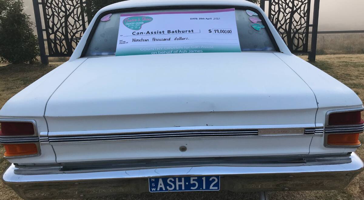 FINE RESULT: The $19,000 cheque for Can Assist Bathurst displayed on Mark James' Ford XY. The number plate honours Mr James' son: the late Ash James.