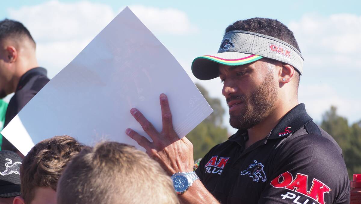 MEET AND GREET: Penrith Panthers hooker Api Koroisau signs autographs for excited local junior rugby league fans at Jack Arrow Park on Thursday. Photo: SAM BOLT