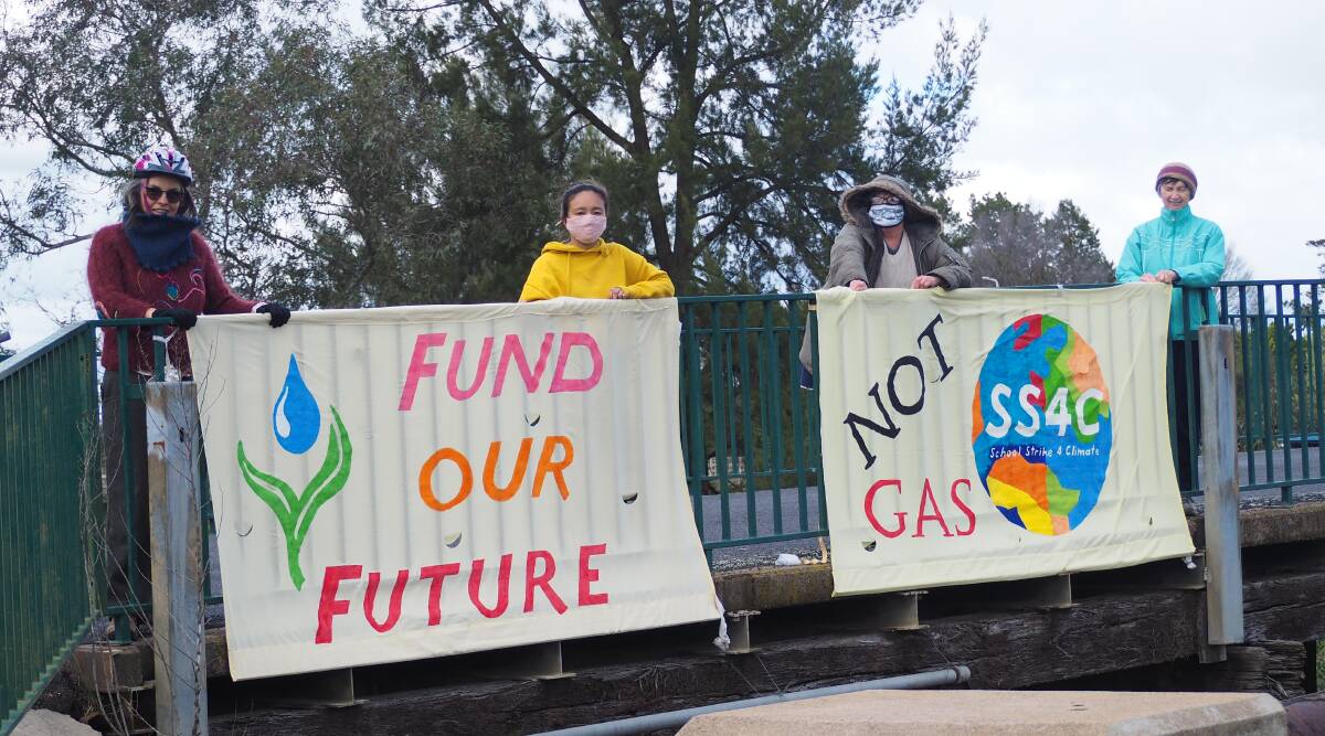 WALK FOR THE PLANET: Bathurst Community Climate Action Network members pictured with demonstration signs at Denison Bridge. Photo: SAM BOLT