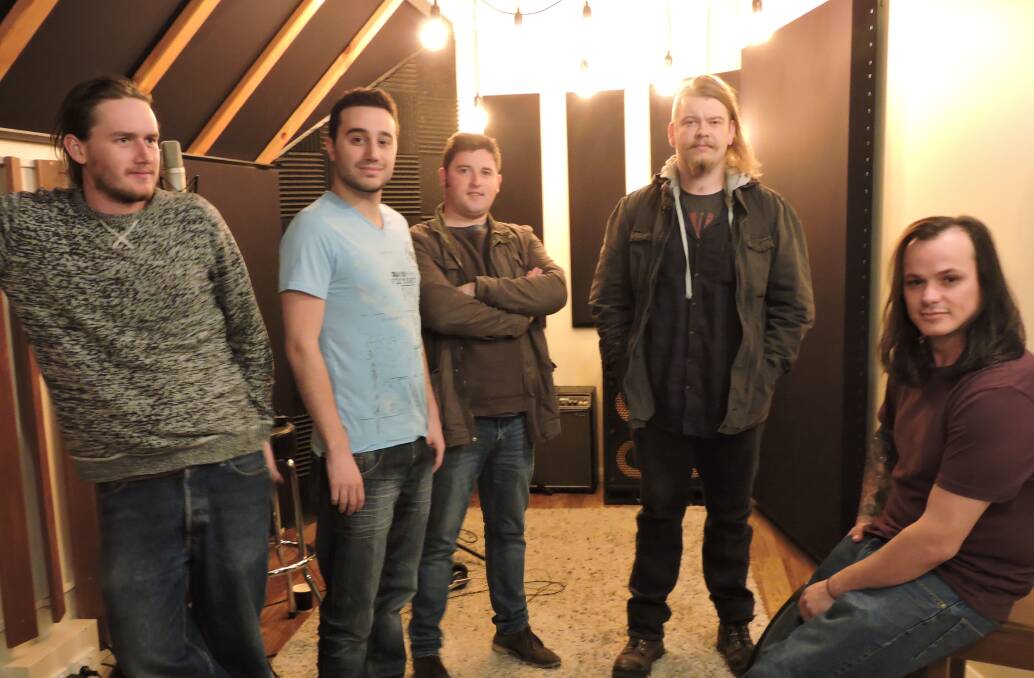 IN THE STUDIO: Tempermore's full lineup, including [from left] Jason Ferguson [guitar,keyboards], Alex Kastrounis [guitar], James Vanderhel [drums], Darcy Coates [bass] and Corey Roche [vocals]. Photo: SUPPLIED