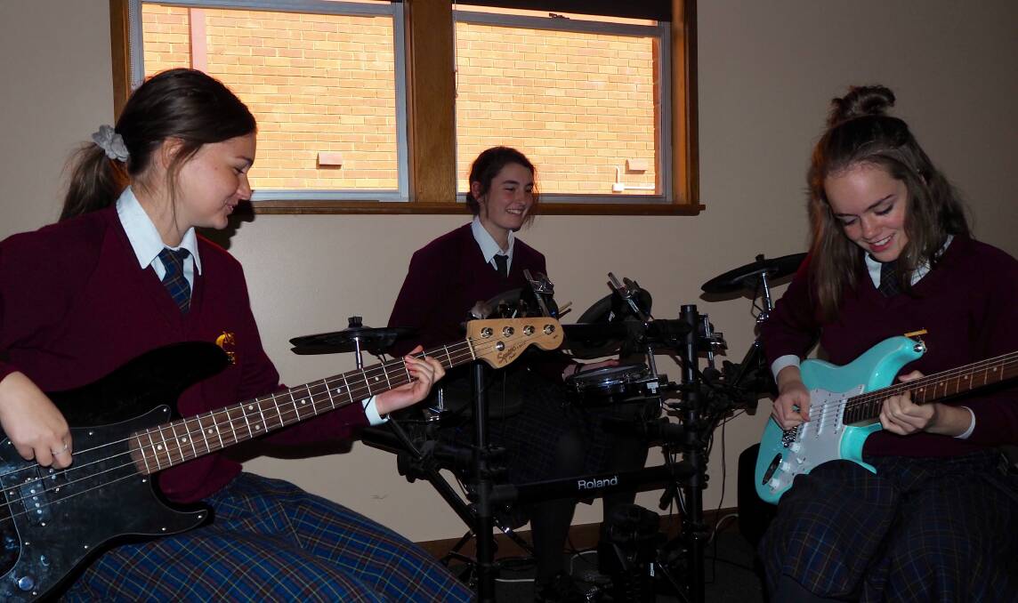 JAMMING OUT A TUNE: MacKillop College Year 10 students Izzy Fulton, Jenna Orpwood and Belle Whitwell will attend a music course at The Academy in Tamworth during the July school holidays. Photo: SAM BOLT