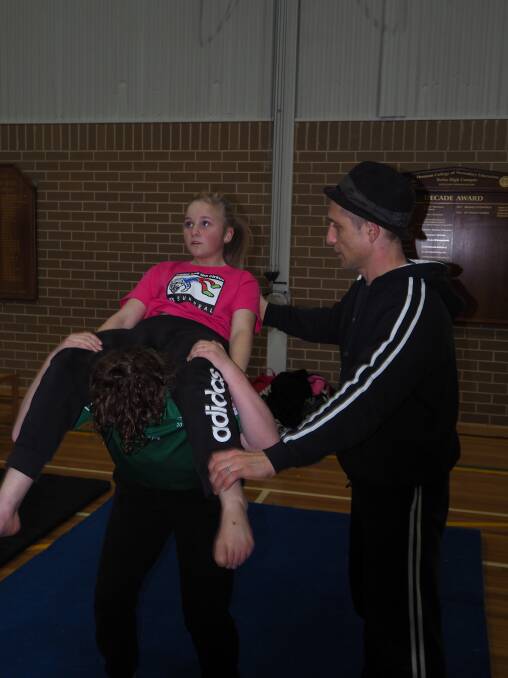 PRACTICE MAKES PERFECT: Stuart Christie helps Kelso High Year 8 students Jessica Christian and Georgia Milligan hone an acrobatic routine. Photo: SAM BOLT