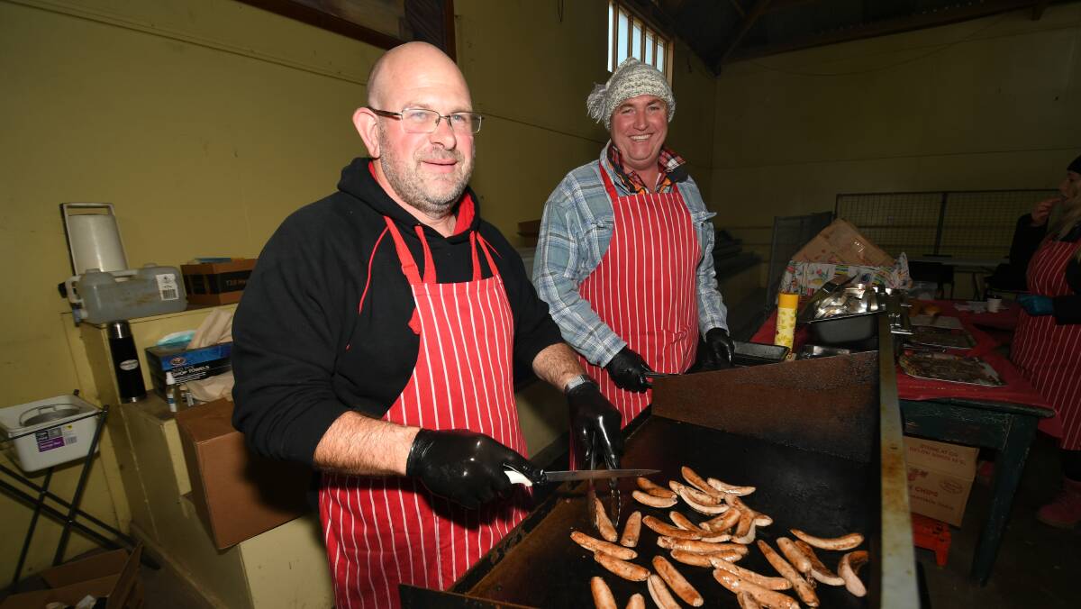 ON THE JOB: Mick Thurkettle and Steve Buckley preparing the 'big breakfast' at last month's Farmers' Market. Photo: CHRIS SEABROOK 062720cfmrkts7
