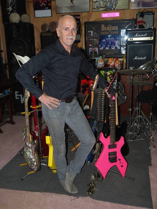 FRET FETISH: Greg Booth with his colourful collection of guitars. Photo: SAM BOLT