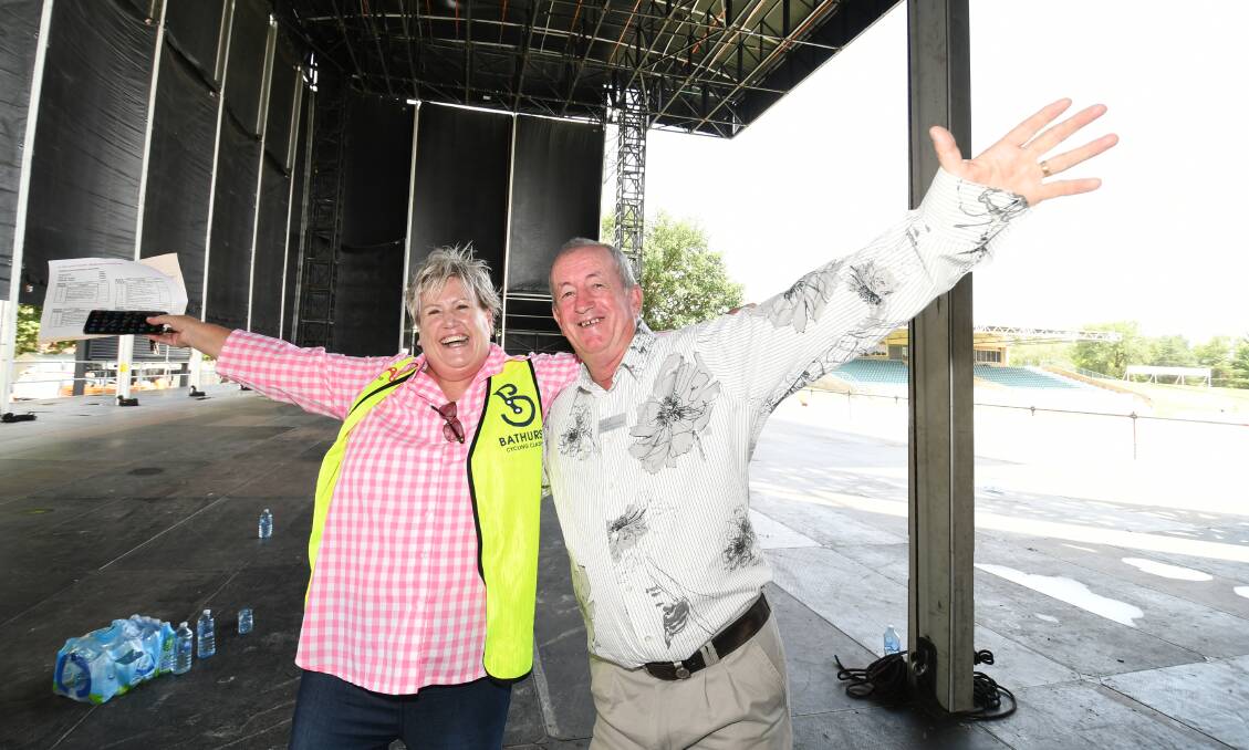 HANDS IN THE AIR: Bathurst councillor Jacqui Rudge and mayor Bobby Bourke on the Carrington Park stage that Sir Elton John will walk out onto for his concert tomorrow night. Photo: CHRIS SEABROOK 012020celton3